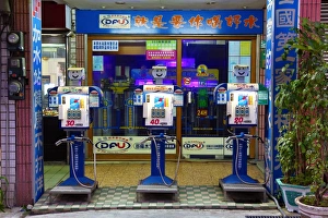 Fresh drinking water pumps with smiling faces at a water station in the street, Tainan, Taiwan Fresh drinking water pumps with smiling faces at a water station in the street, Tainan, Taiwan