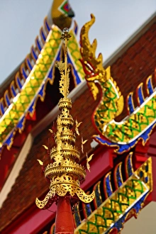 Gold naga roof decorations at Wat Panping Temple in Chiang Mai, Thailand Gold naga roof decorations at Wat Panping Temple in Chiang Mai, Thailand