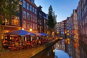 Images Dated 6th June 2016: Houses and restaurants on the Oudezijds Achterburgwal canal at sunset in Amsterdam