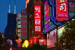 Illuminated Chinese shop signs at night along East Nanjing Road, Shanghai, China Illuminated Chinese shop signs at night along East Nanjing Road, Shanghai, China