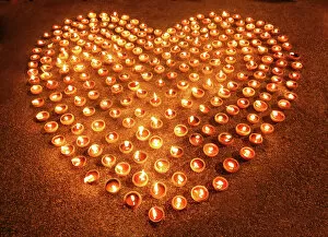 Images Dated 13th November 2016: Love heart shape made out of burning candles and light