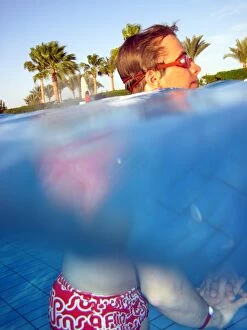 Images Dated 9th April 2011: Man swimming underwater in a swimming pool wearing goggles