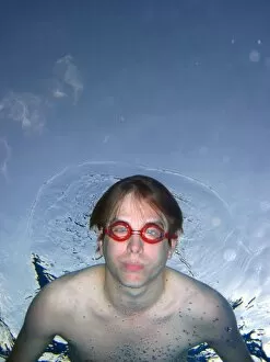 People Collection: Man swimming underwater wearing goggles
