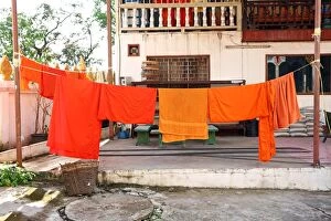 Vientiane, Laos Collection: Orange Buddhist Monk clothes and robes on a washing line, Vientiane, Laos