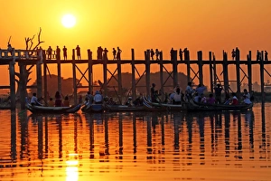 Silhouettes on the U Bein Bridge at sunset, Amarapura, Myanmar