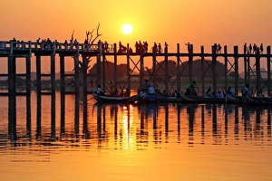 Silhouettes on the U Bein Bridge at sunset, Amarapura, Myanmar
