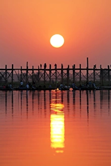 Silhouettes on the U Bein Bridge at sunset, Amarapura, Myanmar