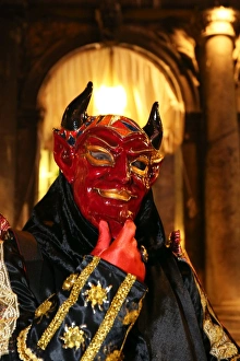 Person wearing a demon mask and costume at the Venice Carnival Person wearing a demon mask and costume at the Venice Carnival