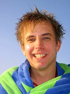 People Collection: Portrait of a smiling man on summer holiday wrapped in a towel
