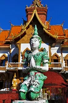 Chiang Mai Collection: Praying statue in front of the ordination hall at Wat Buppharam Temple in Chiang Mai