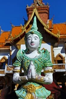 Chiang Mai Collection: Praying statue in front of the ordination hall at Wat Buppharam Temple in Chiang Mai