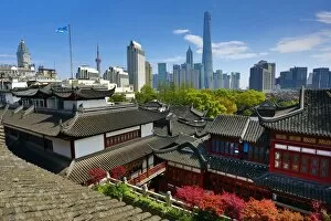 Images Dated 9th April 2015: The Pudong city skyline in Shangha in the background of the Yuyuan gardens in the Old City