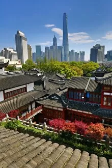 Images Dated 9th April 2015: The Pudong city skyline in Shangha in the background of the Yuyuan gardens in the Old City
