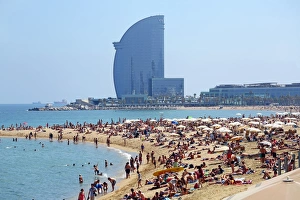 Scene of holiday crowds on the crowded beach and the W hotel, Barcelona, Spain Scene of holiday crowds on the crowded beach and the W hotel, Barcelona, Spain