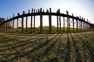 Shadows of the U Bein Bridge across the Taungthaman Lake at sunset in Amarapura Shadows of the U Bein Bridge across the Taungthaman Lake at sunset in Amarapura