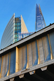 The Shard building and metal railway bridge in London, England The Shard building and metal railway bridge in London, England
