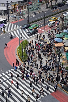 Street scene showing crowds of people crossing the street on a pedestrian crossing in Harajuku, Tokyo, Japan Street scene showing crowds of people crossing the street on a pedestrian crossing in Harajuku, Tokyo, Japan