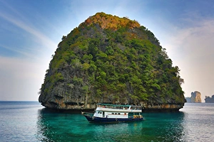 Tour boat and island on Ko Phi Phi Le island, Andaman Sea, Thailand Tour boat and island on Ko Phi Phi Le island, Andaman Sea, Thailand