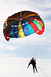 Tourists parascending with a parachute on Patong Beach, Phuket, Thailand Tourists parascending with a parachute on Patong Beach, Phuket, Thailand