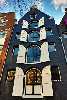 Traditional house with shutters on the windows in Amsterdam, Holland Traditional house with shutters on the windows in Amsterdam, Holland
