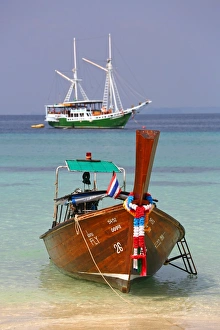 Traditional Thai long tailed boats on Ko Phi Phi Don island beach in Thailand
