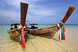 Traditional Thai long tailed boats on Ko Phi Phi Don island beach in Thailand
