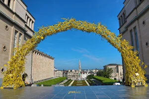 Brussels, Belgium Collection: Yellow Arch of bicycles at the Mont des Arts Gardens and Tower of the Town Hall, Brussels