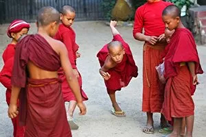 Mandalay, Myanmar Collection: Young Buddhist monks playing at a temple in Amarapura, Mandalay, Myanmar (Burma)